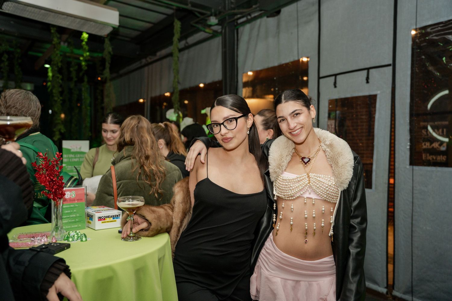 Guests enjoying a social gathering with colorful decor at a modern party venue.
