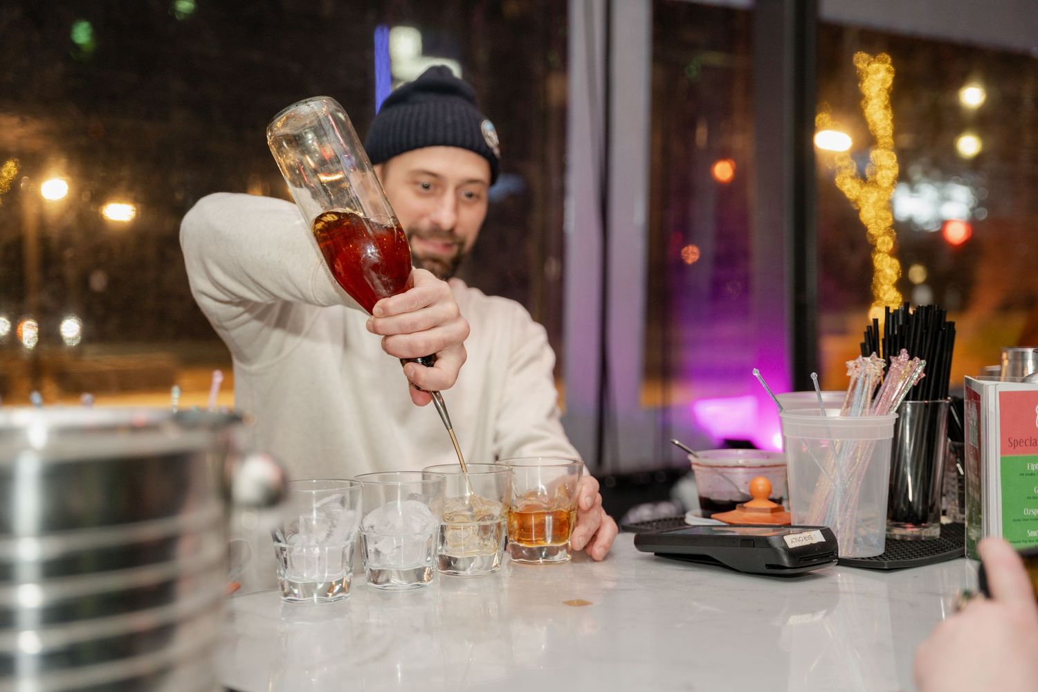 Bar setup with glassware and drinks at an evening event.