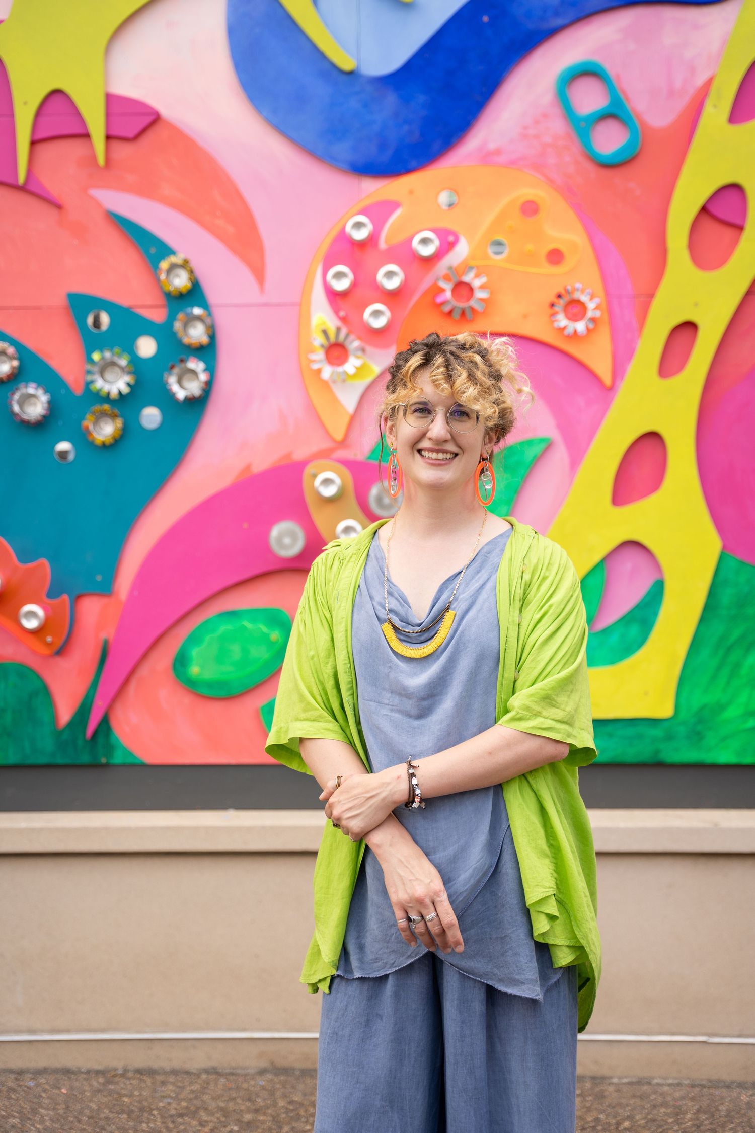 Whimsical wall mural featuring bright colors and abstract designs creates playful backdrop.