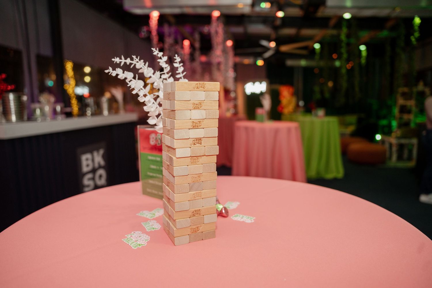 Pink-themed event space with brick accents and decorative floral elements.