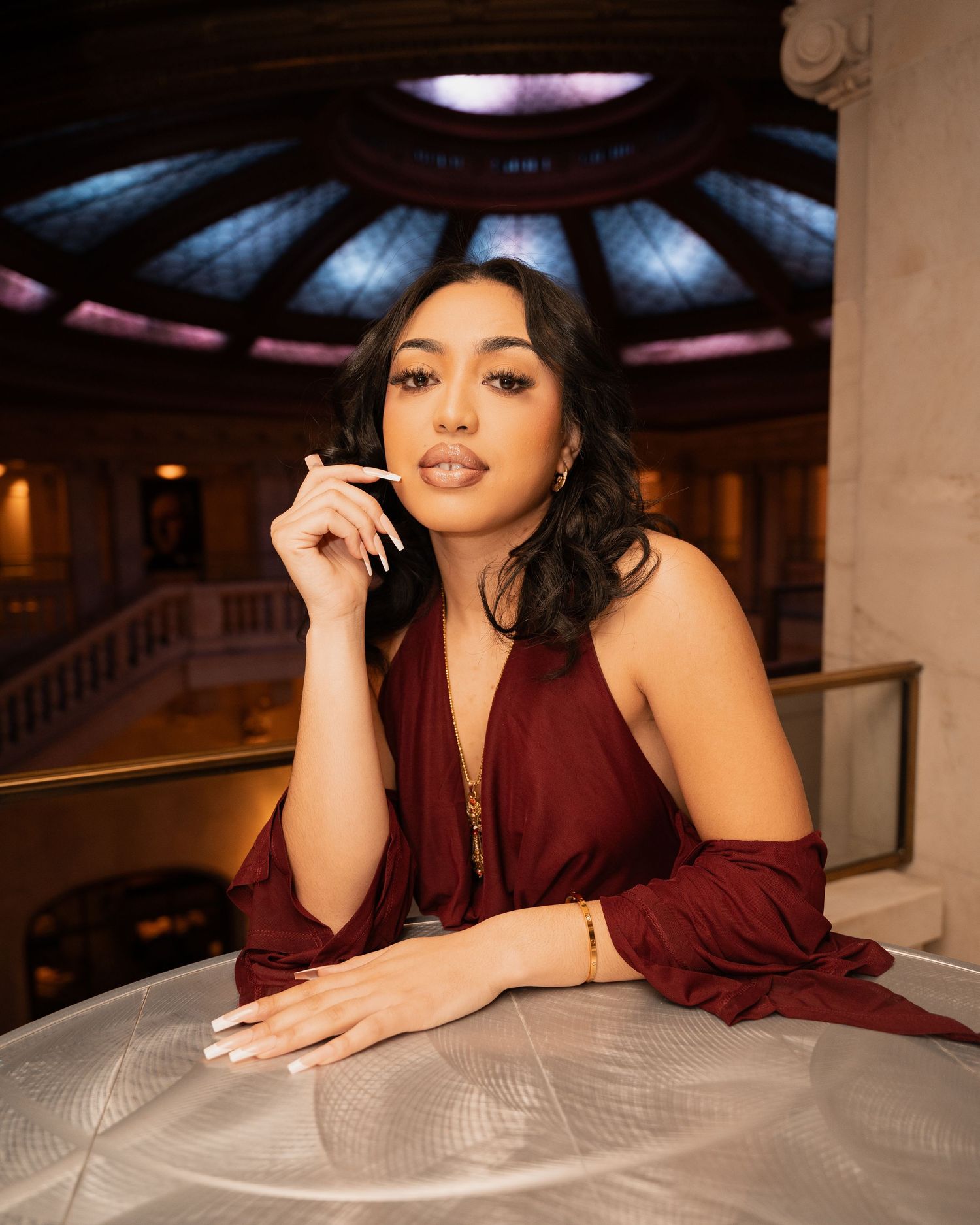 Portrait session in a luxurious indoor setting with dramatic lighting and decor.