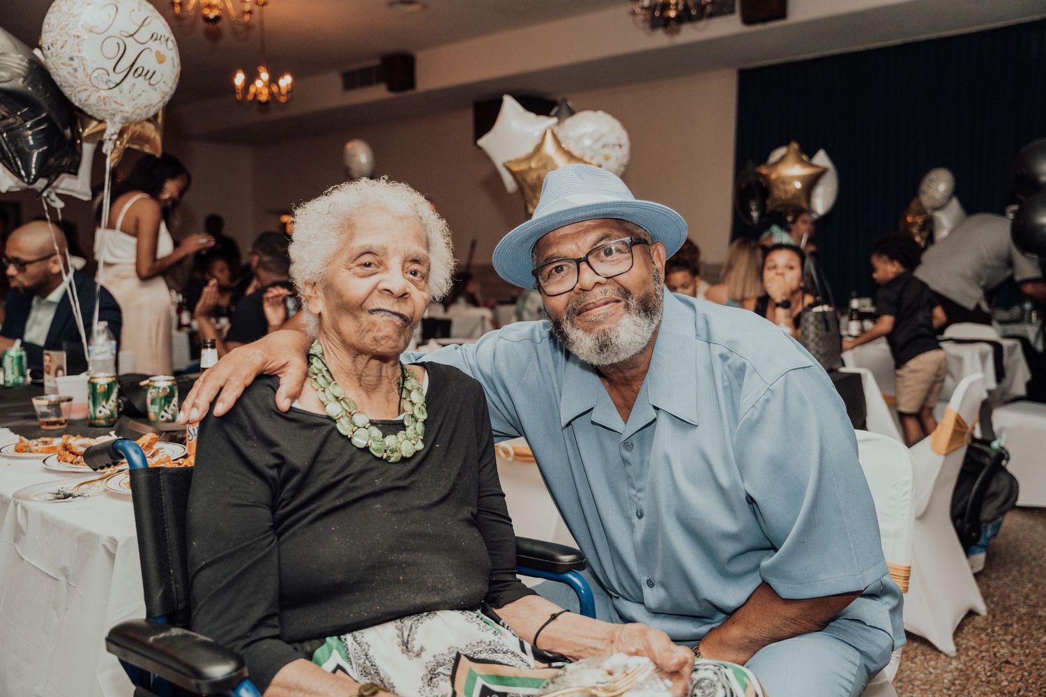 Two people sitting together at a decorated table during a special celebration.