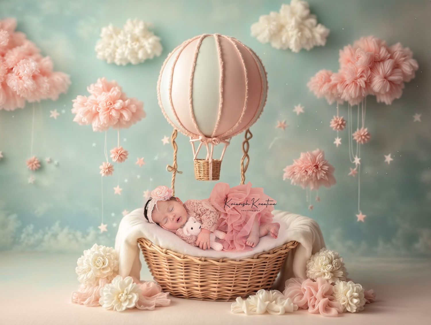 Pink clouds and hot air balloons create a dreamy nursery scene with vintage styling and soft pastel colors.