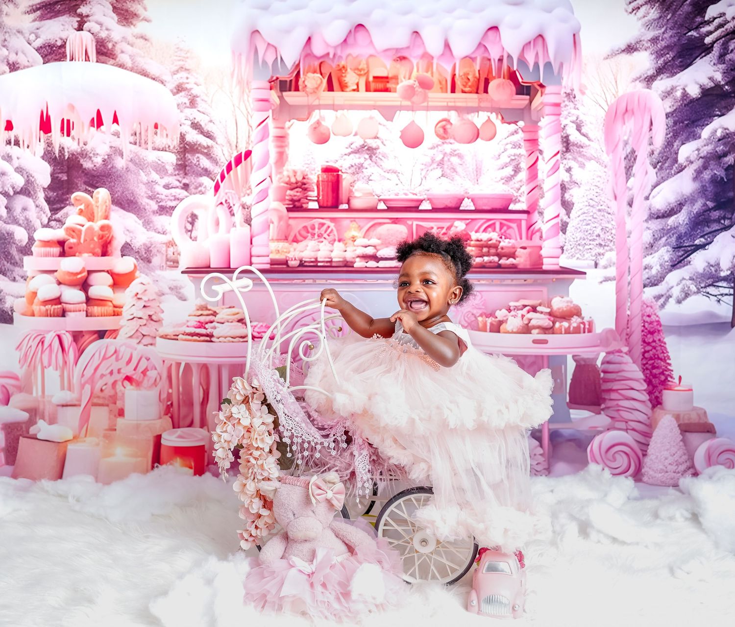 Magical pink and white winter wonderland dessert display with snowy decorations, candy canes, and a small decorated cart.