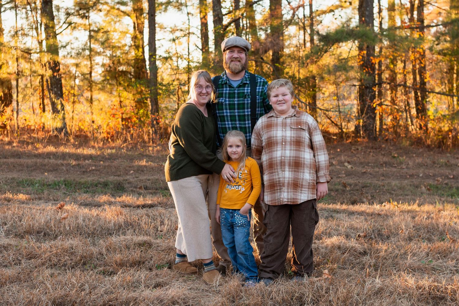 young family of 4 together in fall