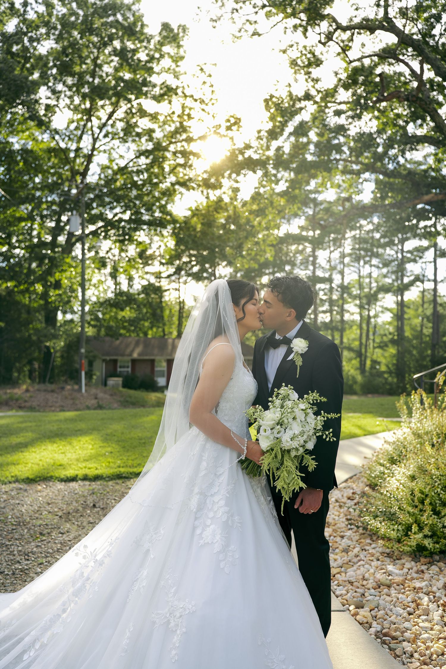 A beautiful bride and groom portrait taken outside during sunset while holding a gorgeous bouquet