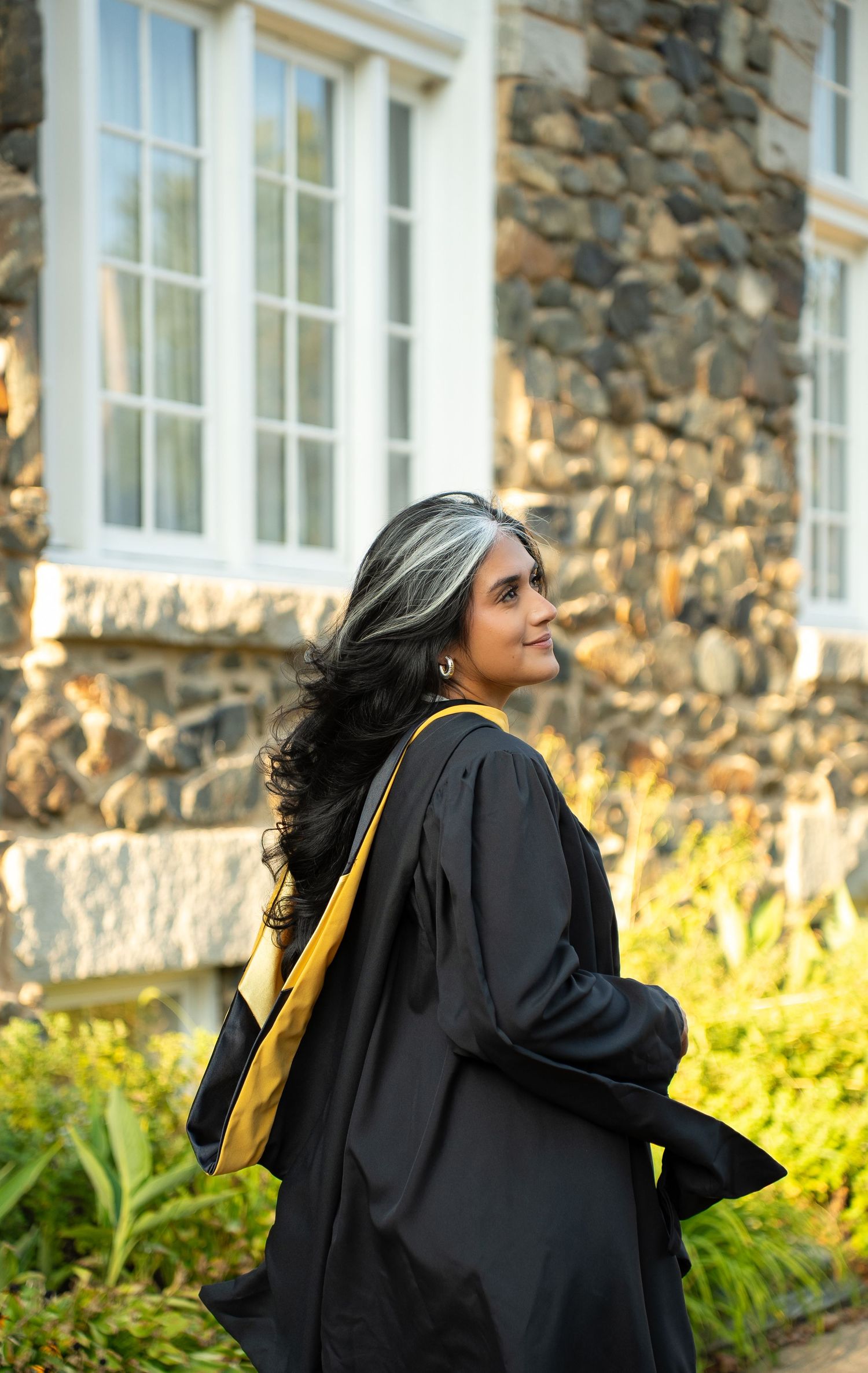 Graduate celebrating their achievement during a graduation photography session in Maryland.