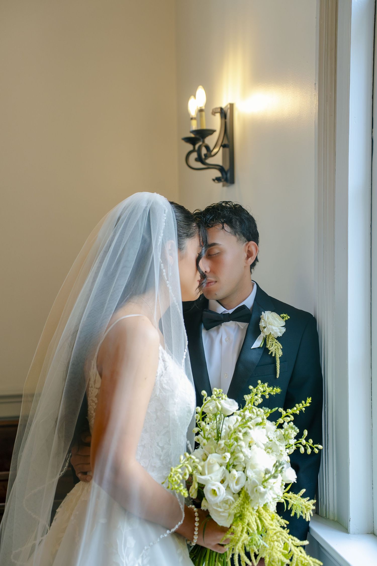 a bride and groom looking into each others eyes during their pre ceremony photoshoot by Maryland based photographer during their wedding day