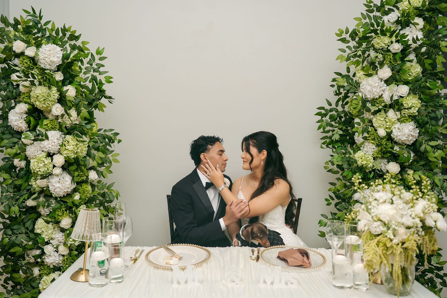 gorgeous greenery sweetheart table with bride and groom in love captured beautifully