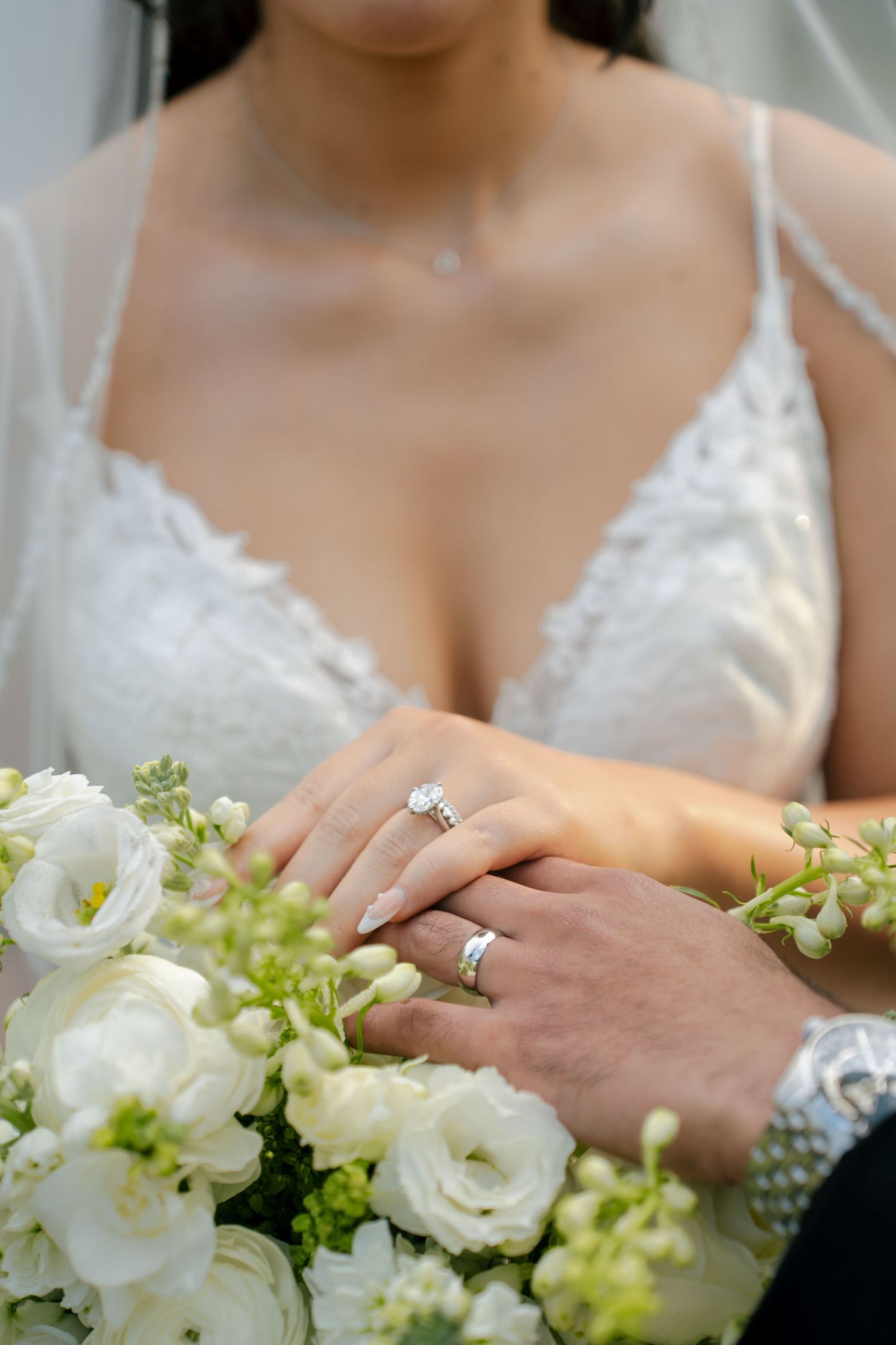 Close-up of bride and groom wedding rings displayed on a bridal bouquet during a Maryland wedding.