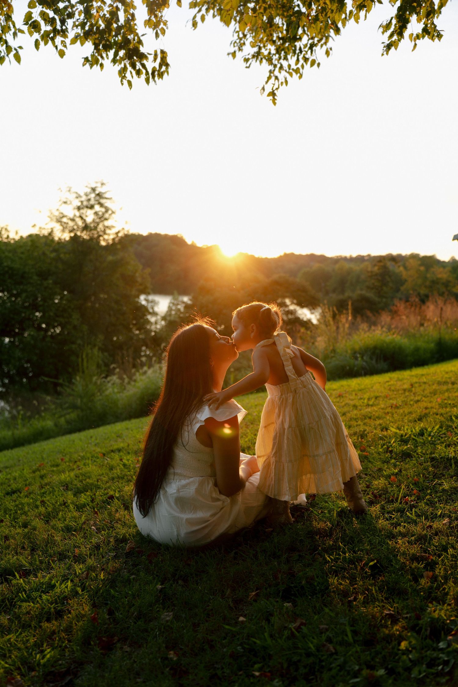 Mom and daughter sharing a sweet moment during a golden hour Mommy and Me photography session in Maryland.