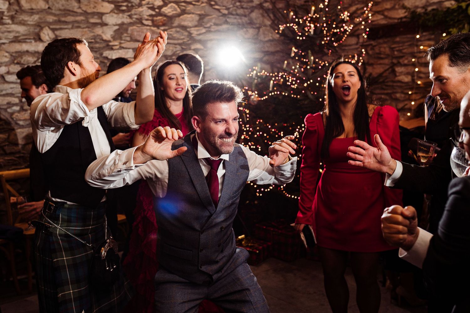 Dance floor photography - A guest dances and poses with his hand out and his teeth clenched