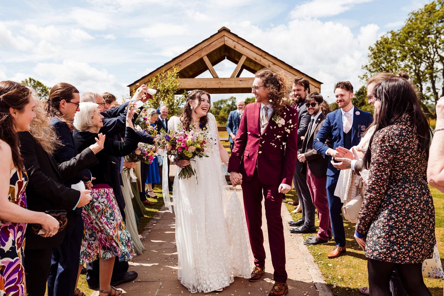 Vintage wedding at the Eden Wedding Barn - Bride and Groom smile through confetti
