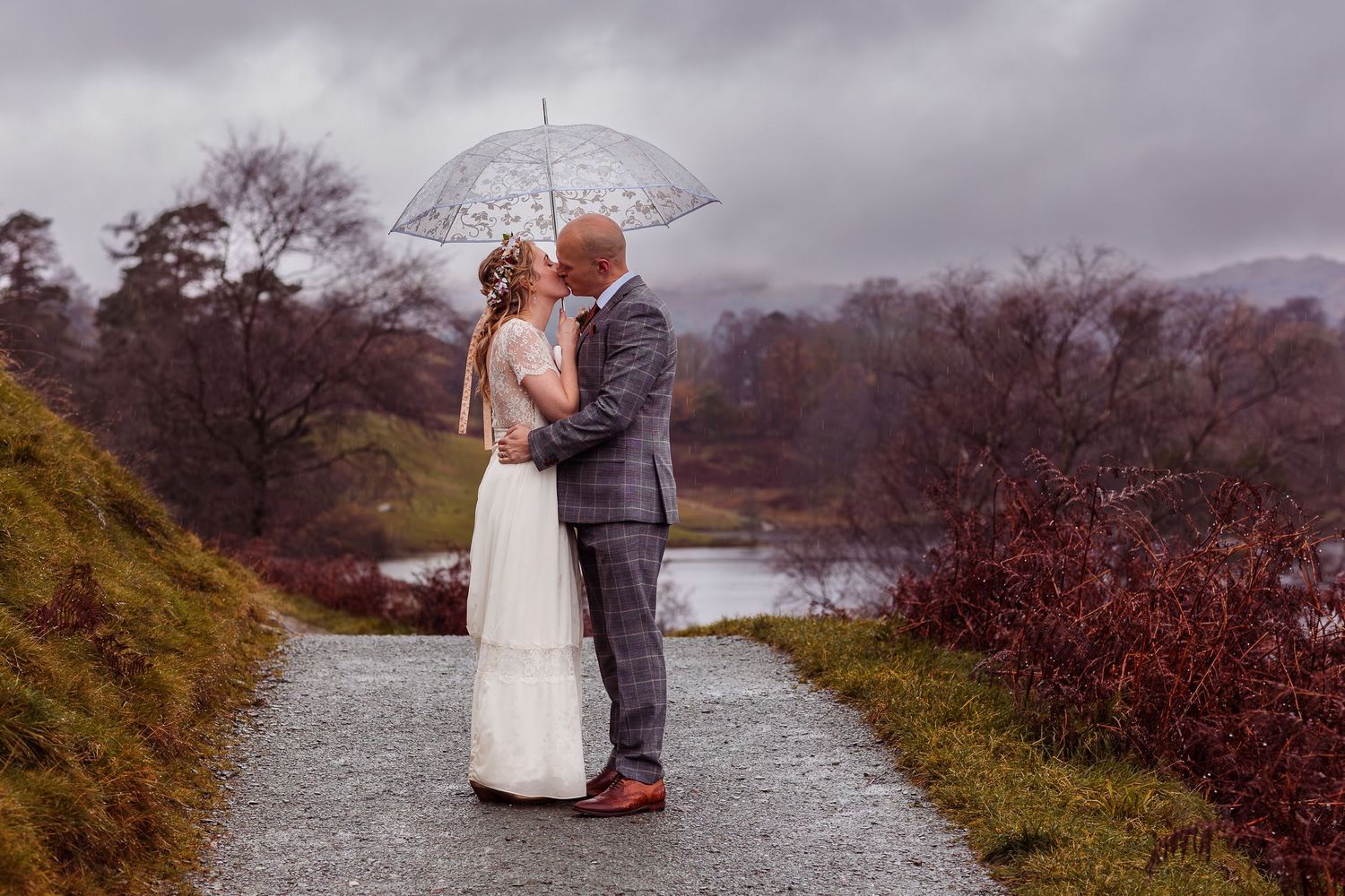 Lake District Wedding - Tarn Howes, couple embrace the rain