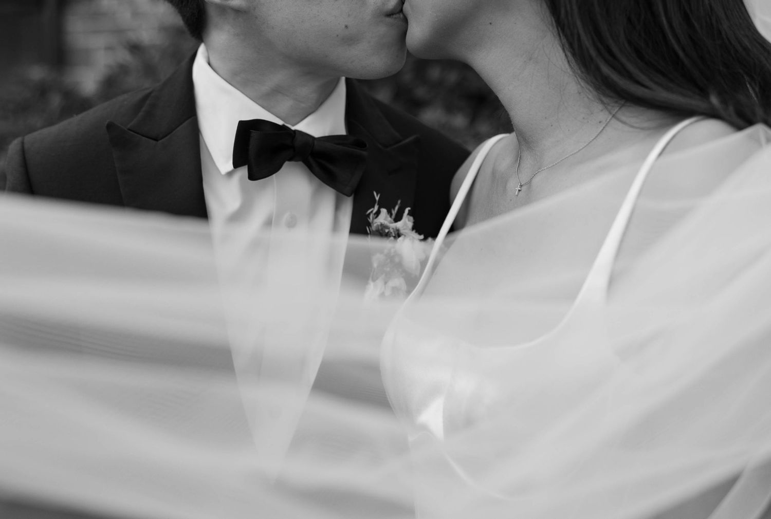 Close-up black and white shots of a couple sharing tender moments.