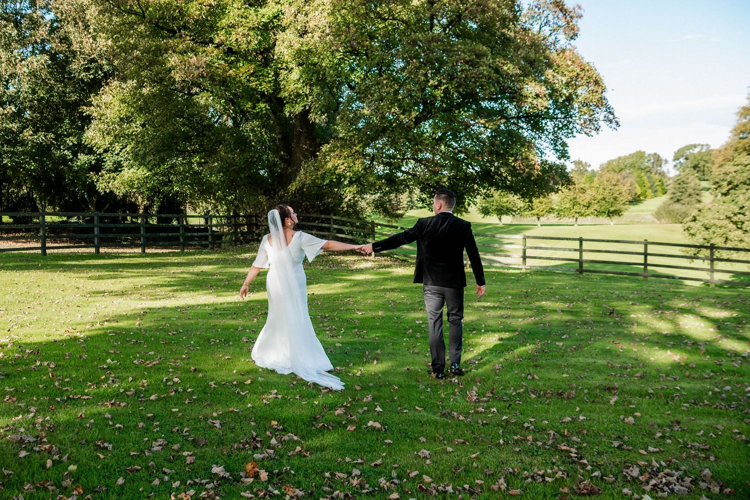 Bride and groom walking together during wedding photoshoot at Mount Temple Golf Course Ireland.