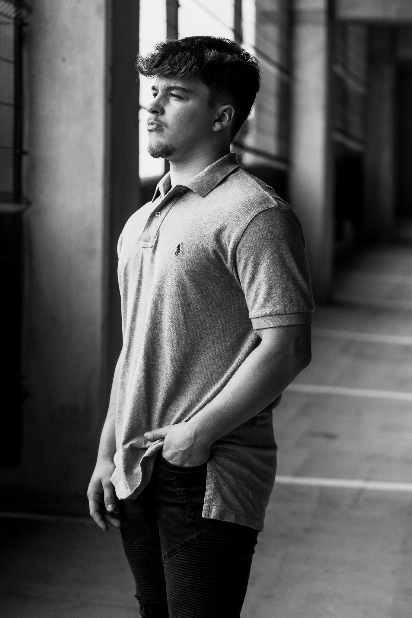 Black-and-white portrait of a man standing in a downtown parking garage in Columbus, Ohio, photographed by Jamie Macey Photography