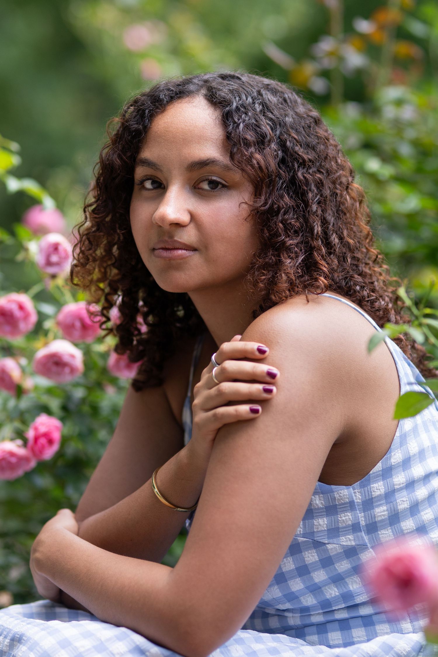 Senior posing in rose garden for her senior session in Columbus Ohio by Jamie Macey Photography