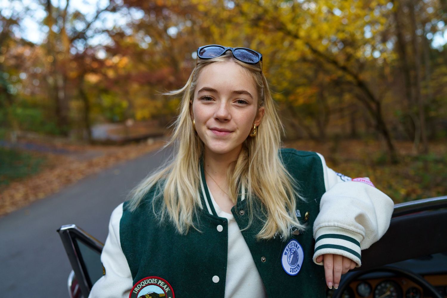 High school senior wearing a varsity jacket outdoors in Columbus, Ohio, photographed by Jamie Macey Photography