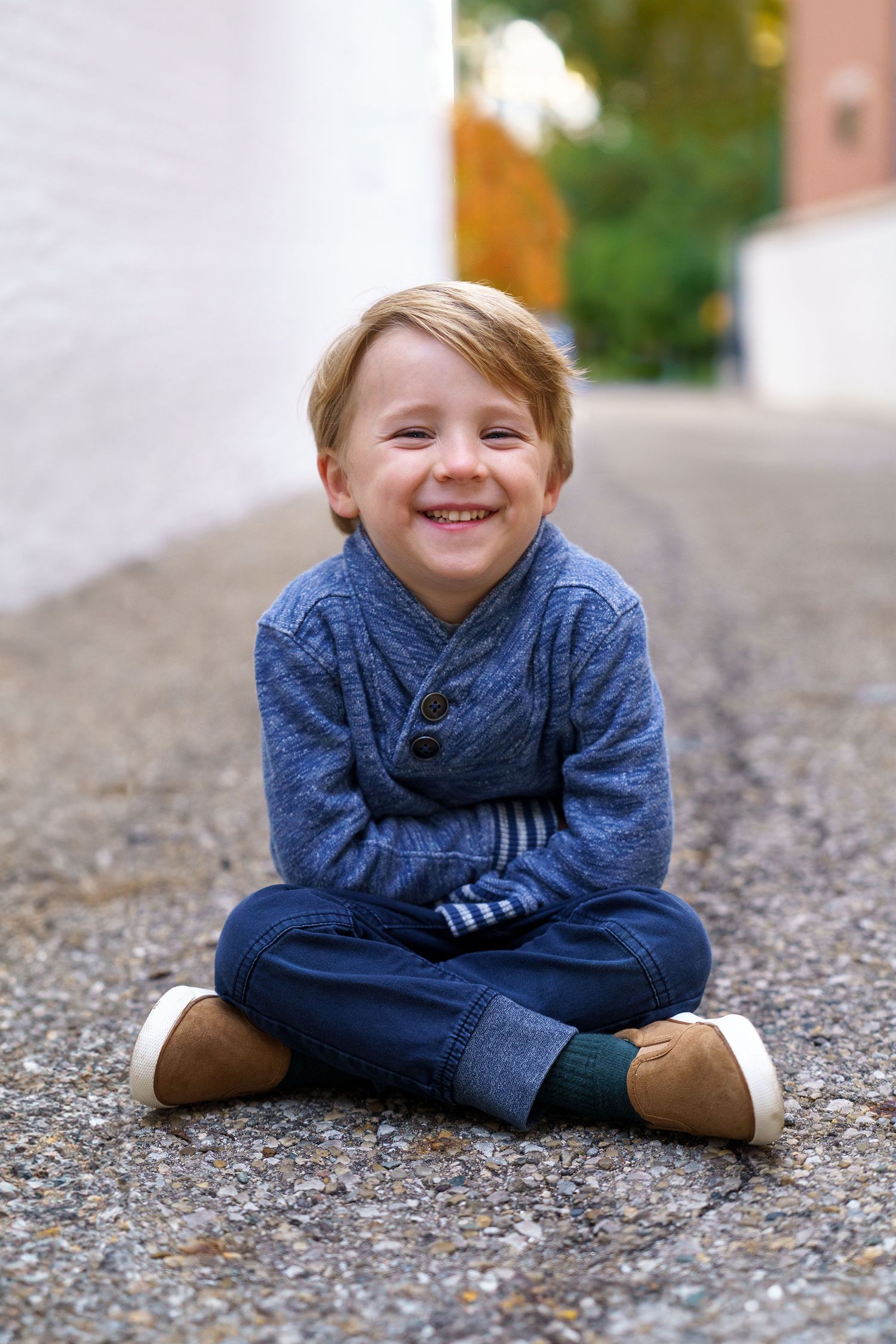 Young child sitting outdoors during a portrait session in Columbus, Ohio, photographed by Jamie Macey Photography