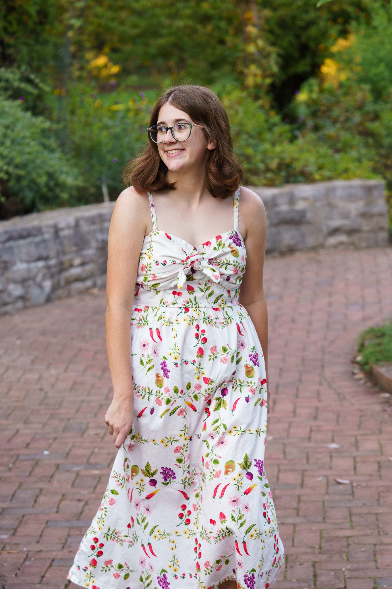 High school senior girl wearing a floral dress at Inniswood Metro Gardens in Columbus, Ohio, photographed by Jamie Macey Photography