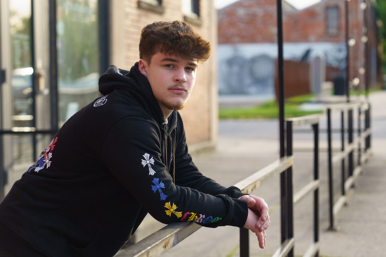 High school senior boy posing in an urban setting in Columbus, Ohio, photographed by Jamie Macey Photography