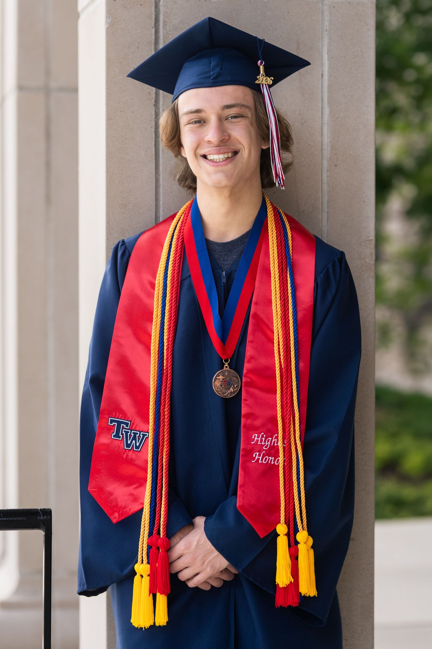 High school graduate wearing a cap and gown in Columbus, Ohio, photographed by Jamie Macey Photography