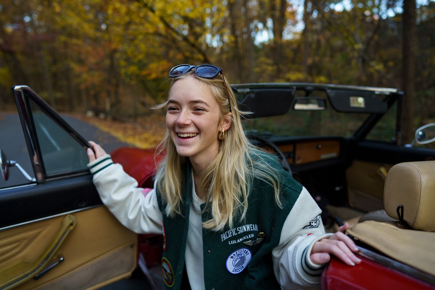 High school senior girl laughing beside a convertible in Columbus, Ohio, photographed by Jamie Macey Photography