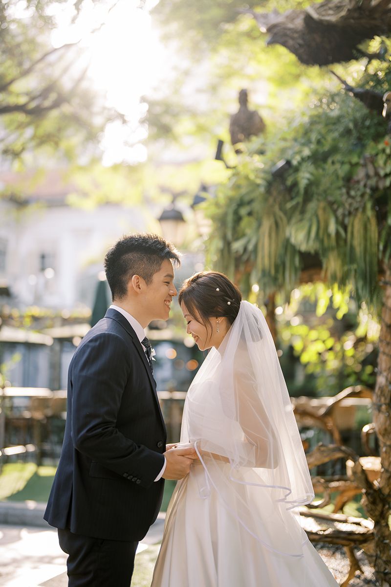 Newlyweds share tender moments during their outdoor garden wedding photoshoot.