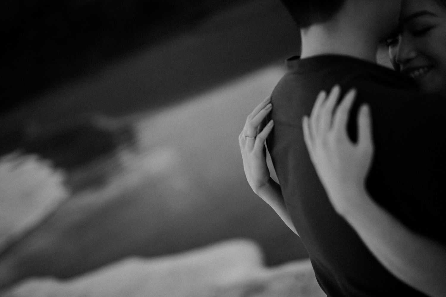 Artistic black and white close-up of intimate wedding moment.
