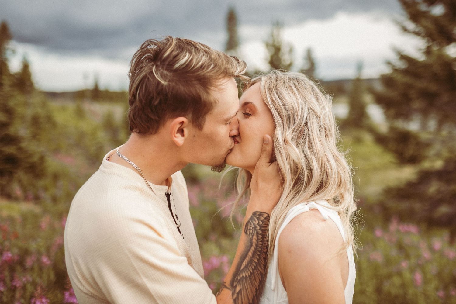 A couple giving a big kiss, photographed by Kristy Baker Photography in Steamboat Springs, Colorado.