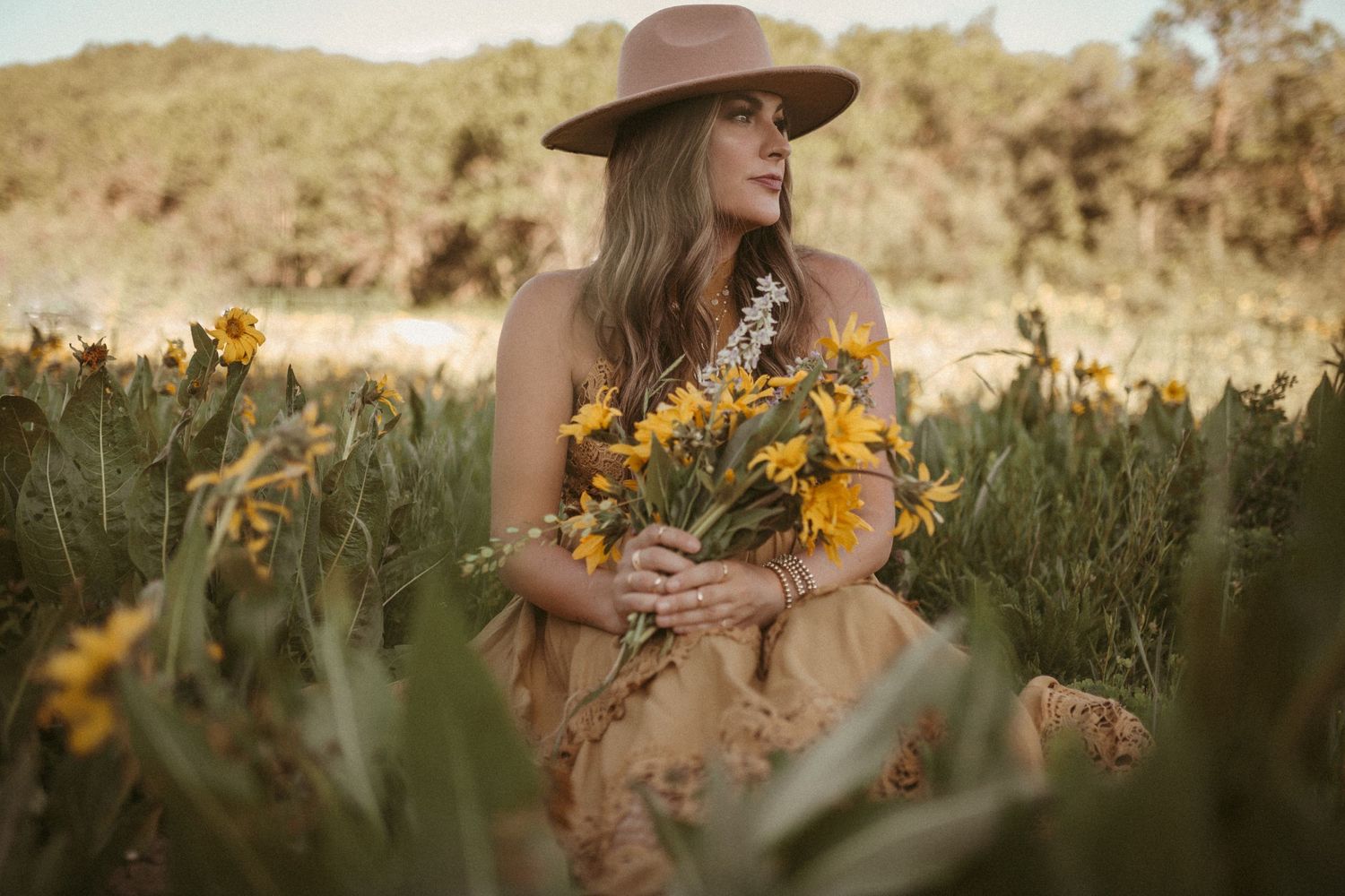 Photo of a woman holding a bouquet of wildflowers by Kristy Baker Photography, a local Steamboat Springs, Colorado photographer.