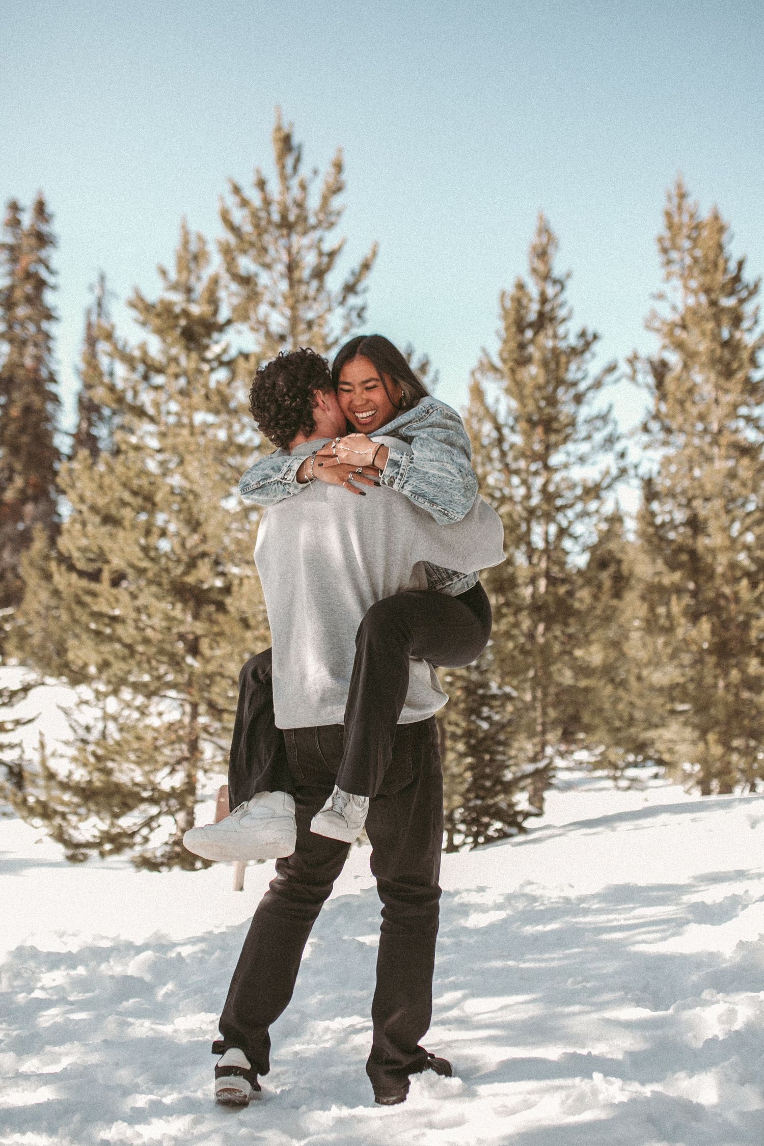 A man holding up his girlfriend after she jumped into his arms, photographed by Kristy Baker Photography in Steamboat Springs, Colorado.