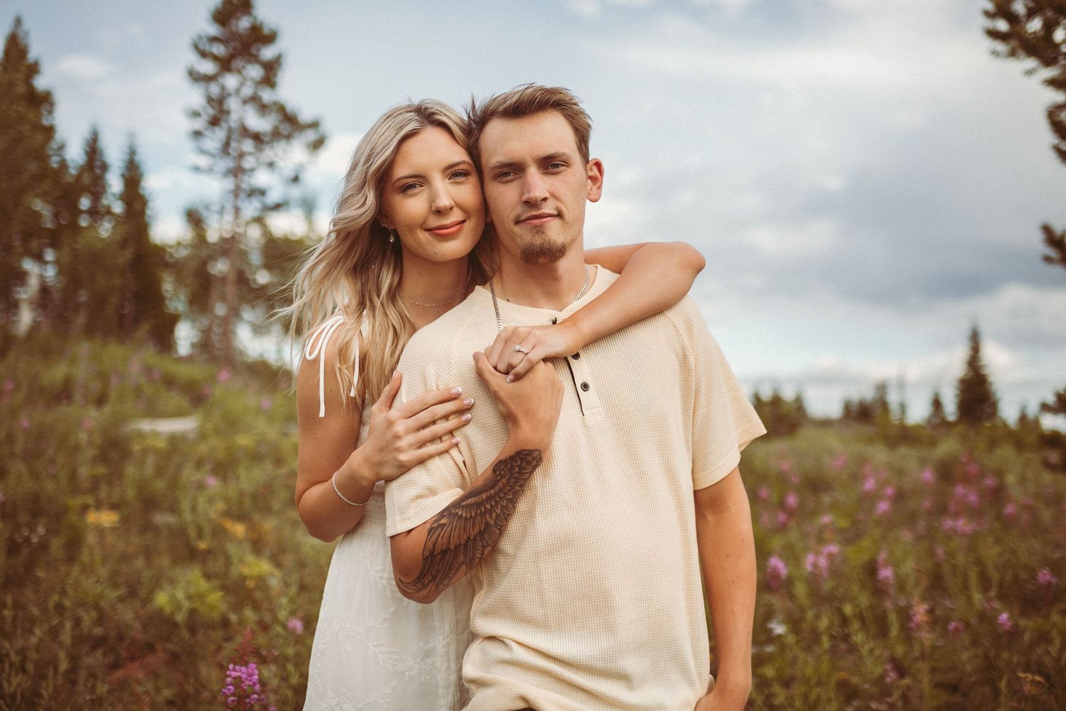 A couple holding on to each other and looking at the camera, photographed by Kristy Baker Photography in Steamboat Springs, Colorado