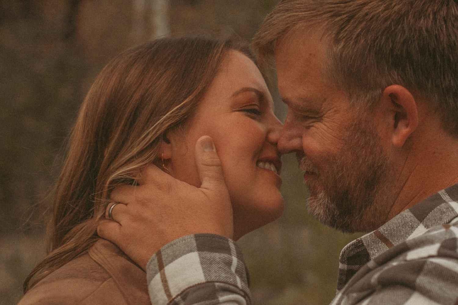 A couple leaning in and about to kiss each other, photographed by Kristy Baker Photography in Steamboat Springs, Colorado.