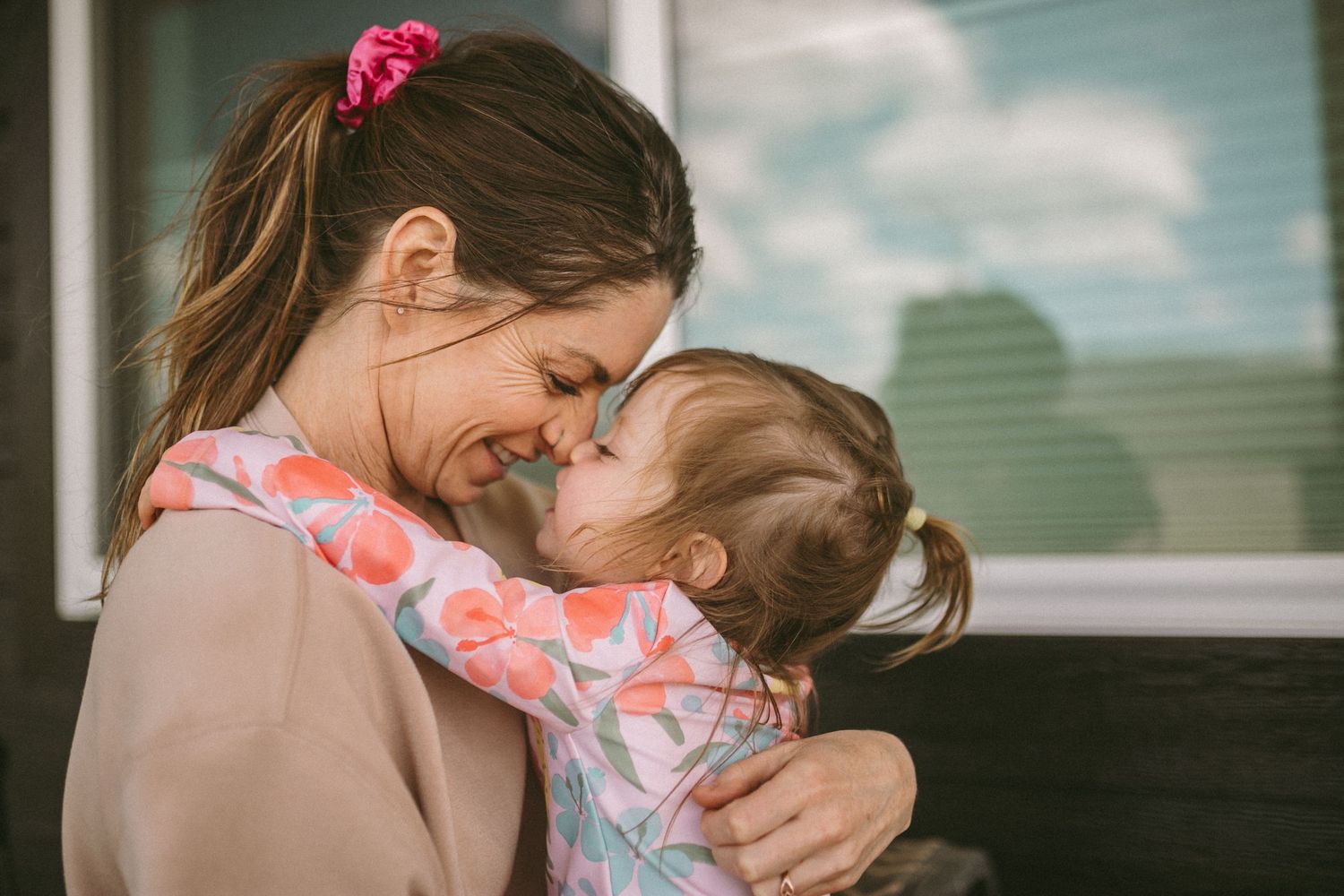 A mother and young daughter rub noses and are smiling at each other, photographed by Kristy Baker Photography in Steamboat Springs, CO.