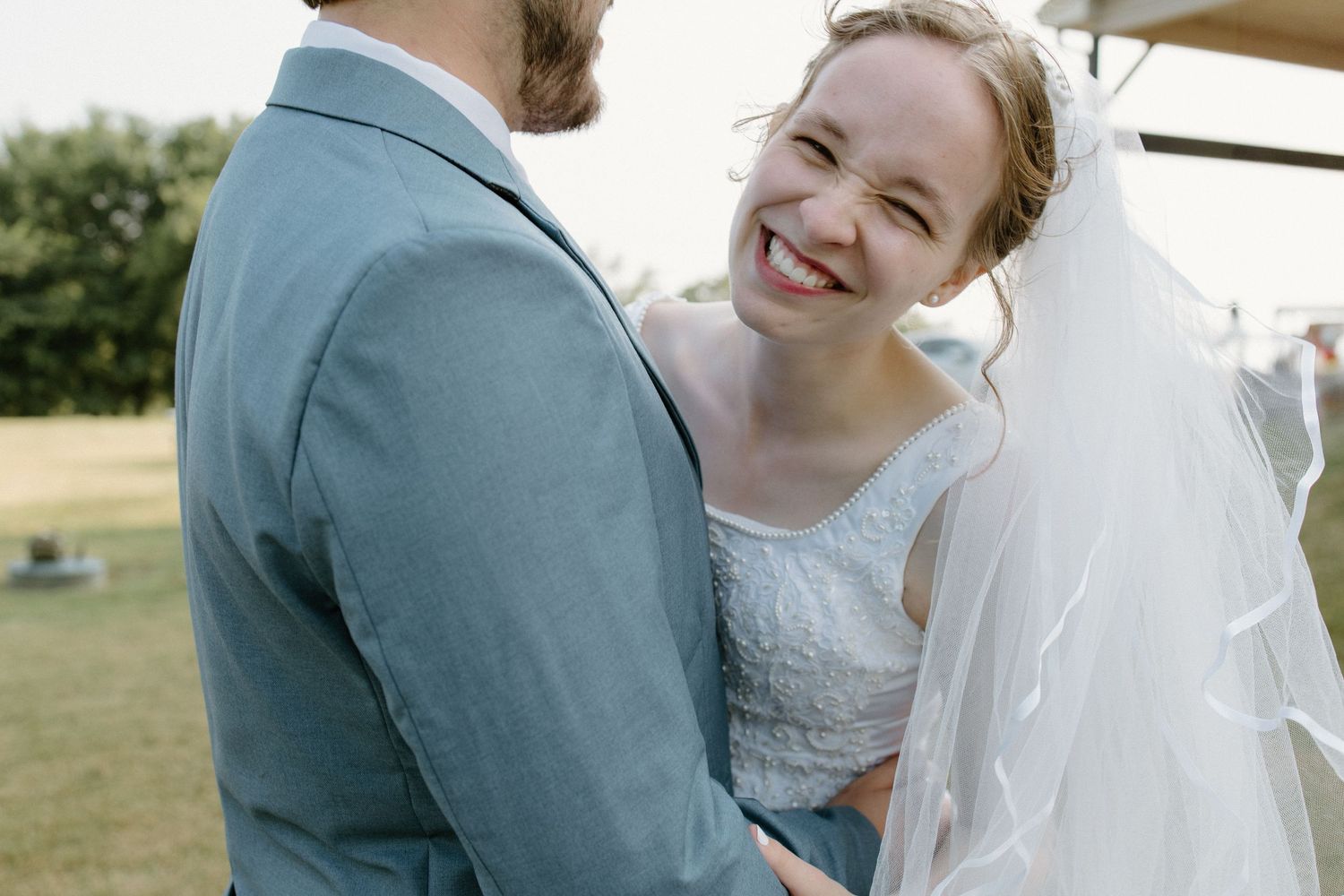 Romantic couple portrait outside family church in Oklahoma, taken by professional Oklahoma wedding photographer