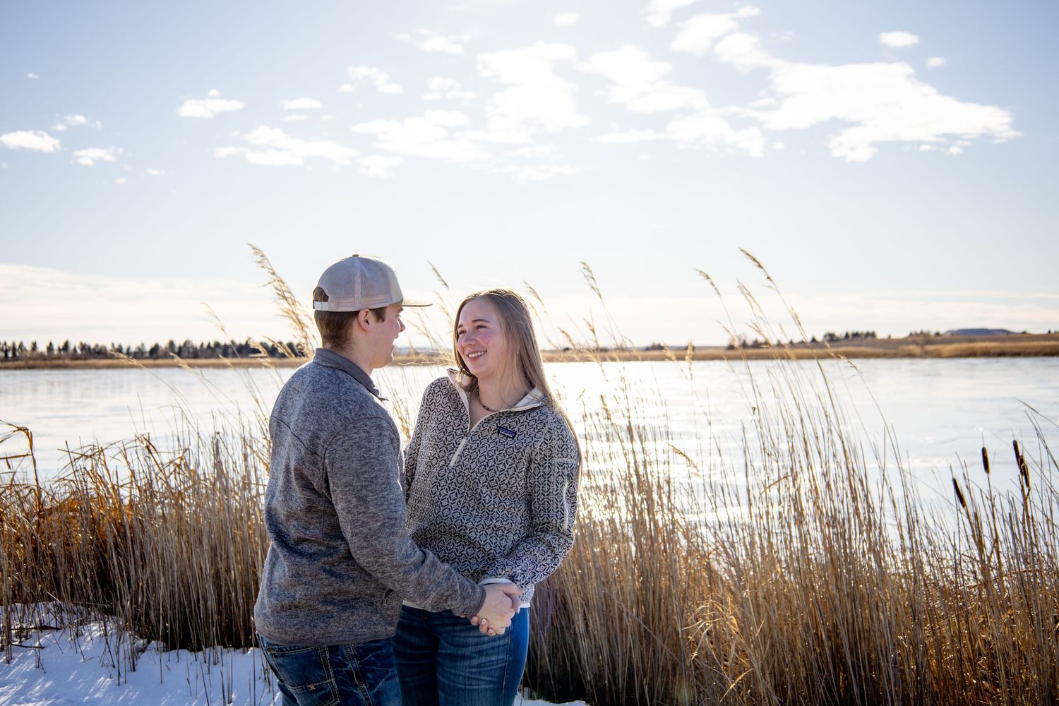 Dickinson photographer North Dakota capturing couple embracing outdoors with natural light and genuine emotion.