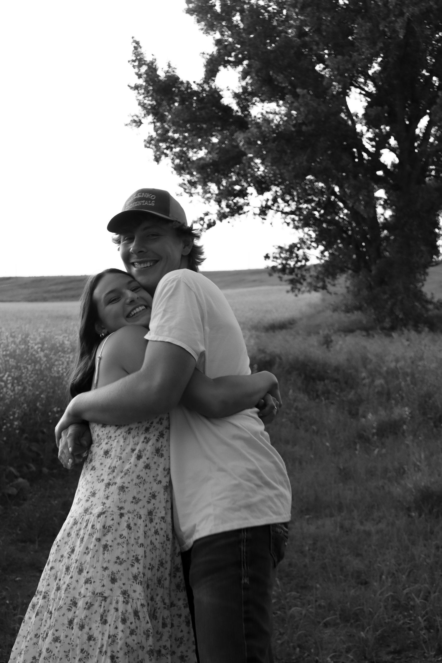Prairie Glow Photography North Dakota couples photo with candid laughter, natural light, and authentic storytelling.