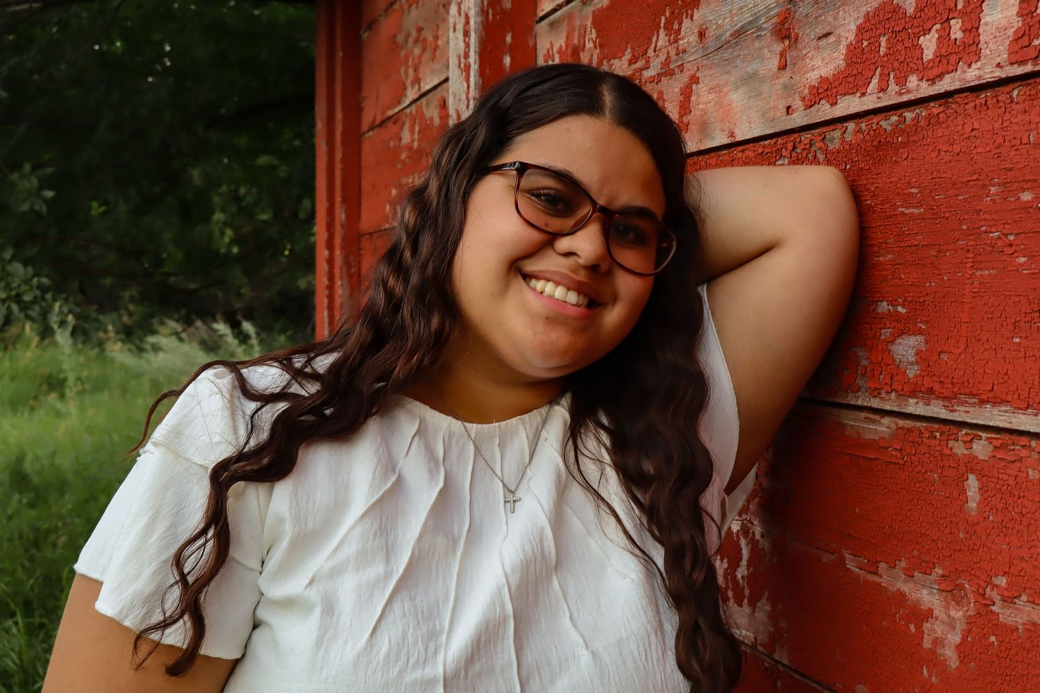 Dickinson photographer North Dakota senior portrait with natural smile and beautiful prairie backdrop.