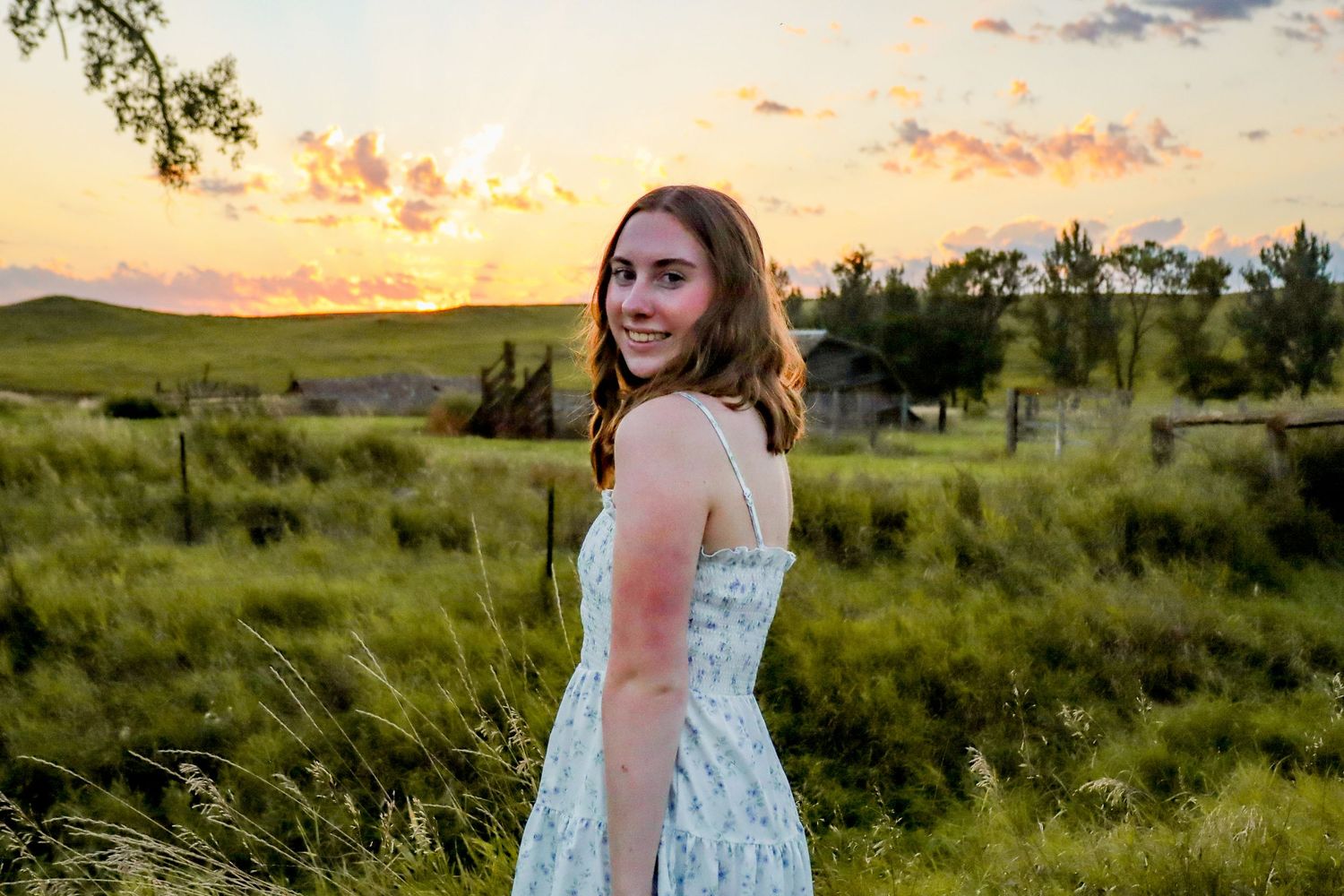 Dickinson photographer North Dakota senior portrait featuring authentic smile and prairie backdrop.