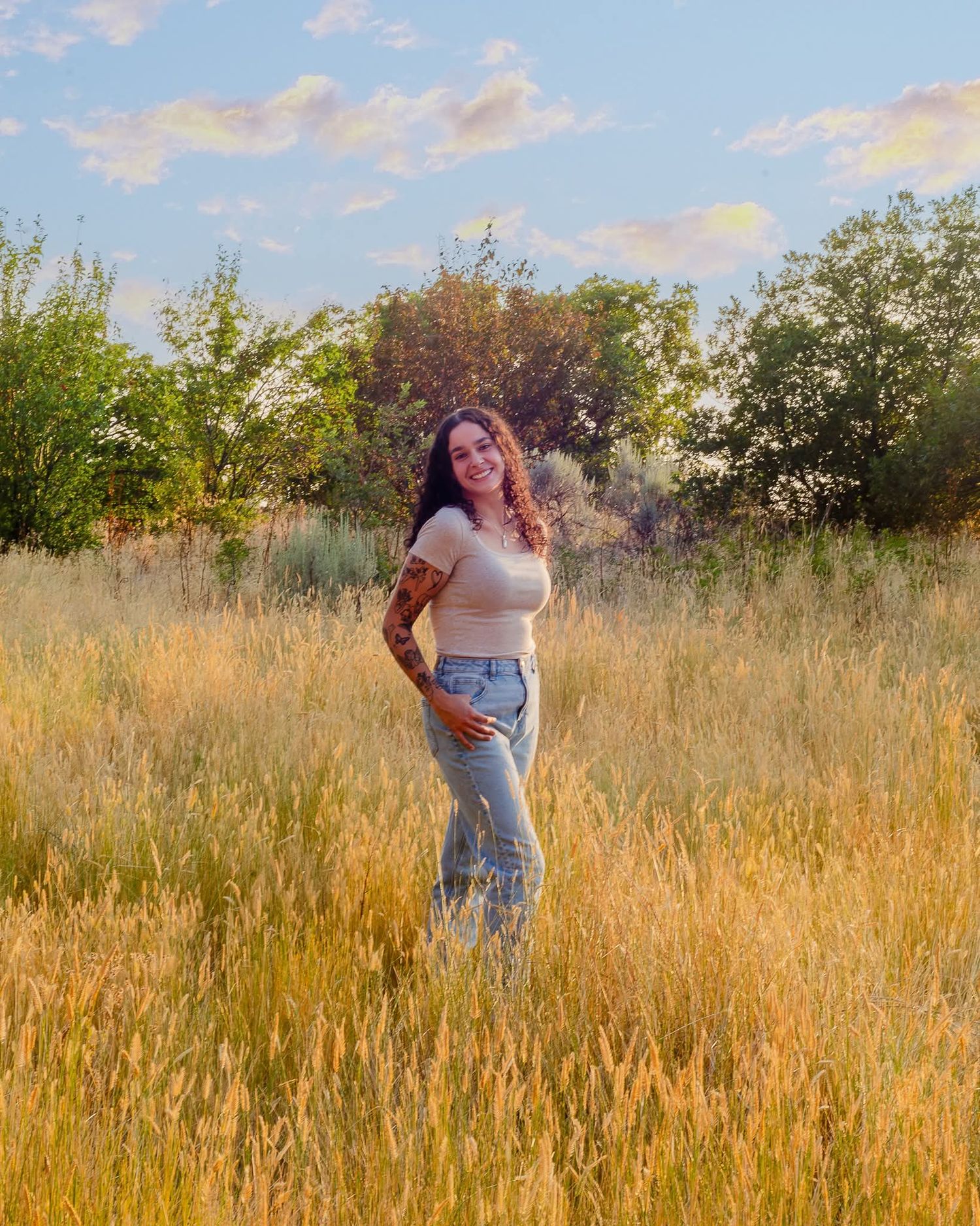 Northern Utah portrait photographer capturing woman in golden field at sunset lifestyle session