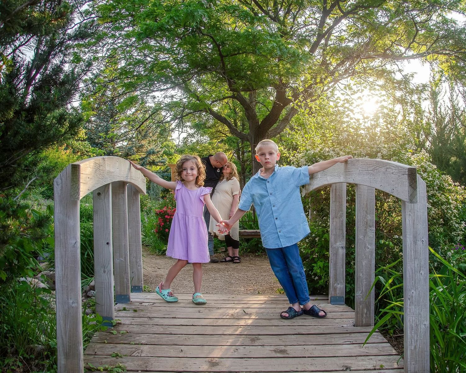 Family of four smiling during Northern Utah portrait session in natural setting