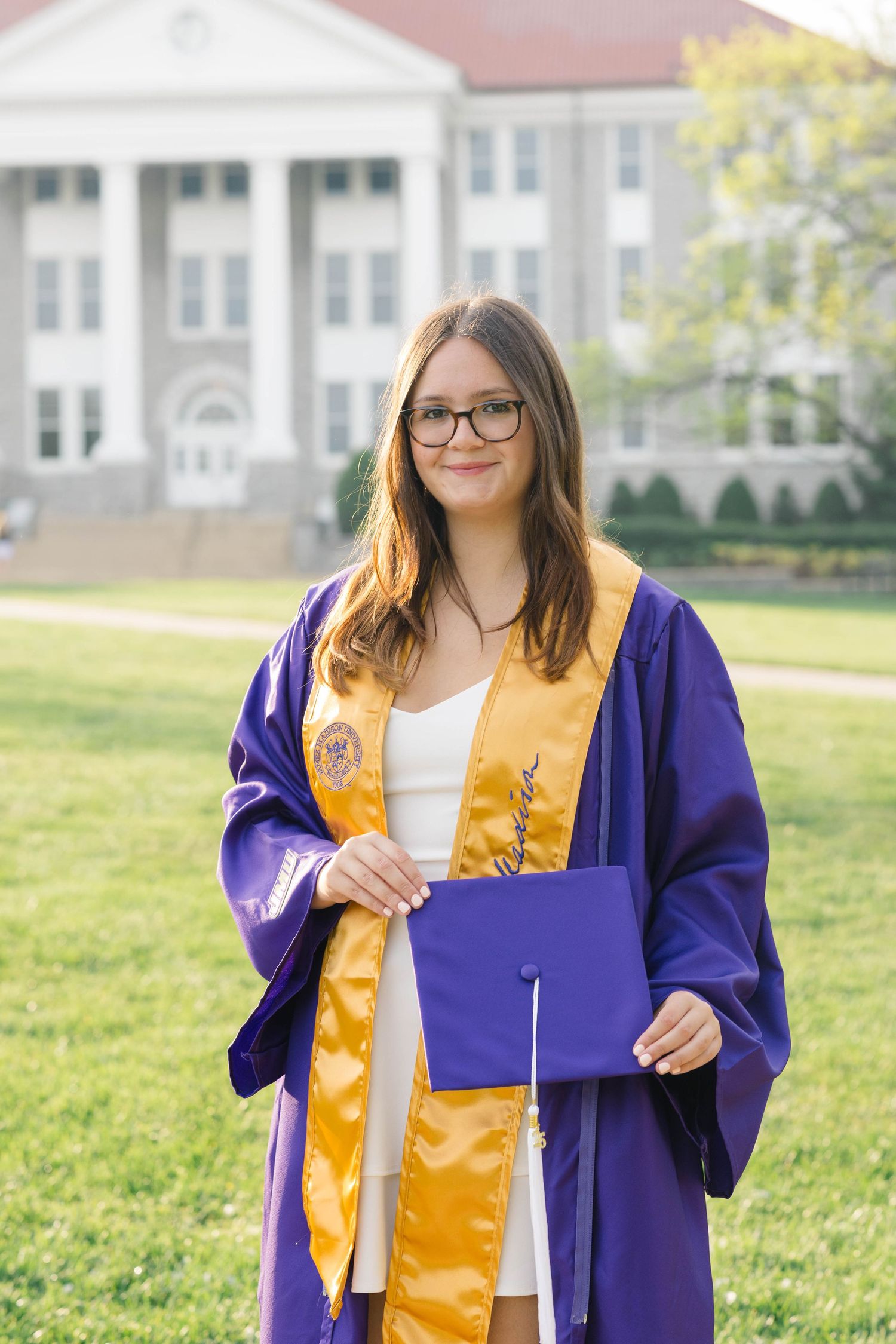An image of a graduate from James Madison University on campus in Harrisonburg, Virginia.
