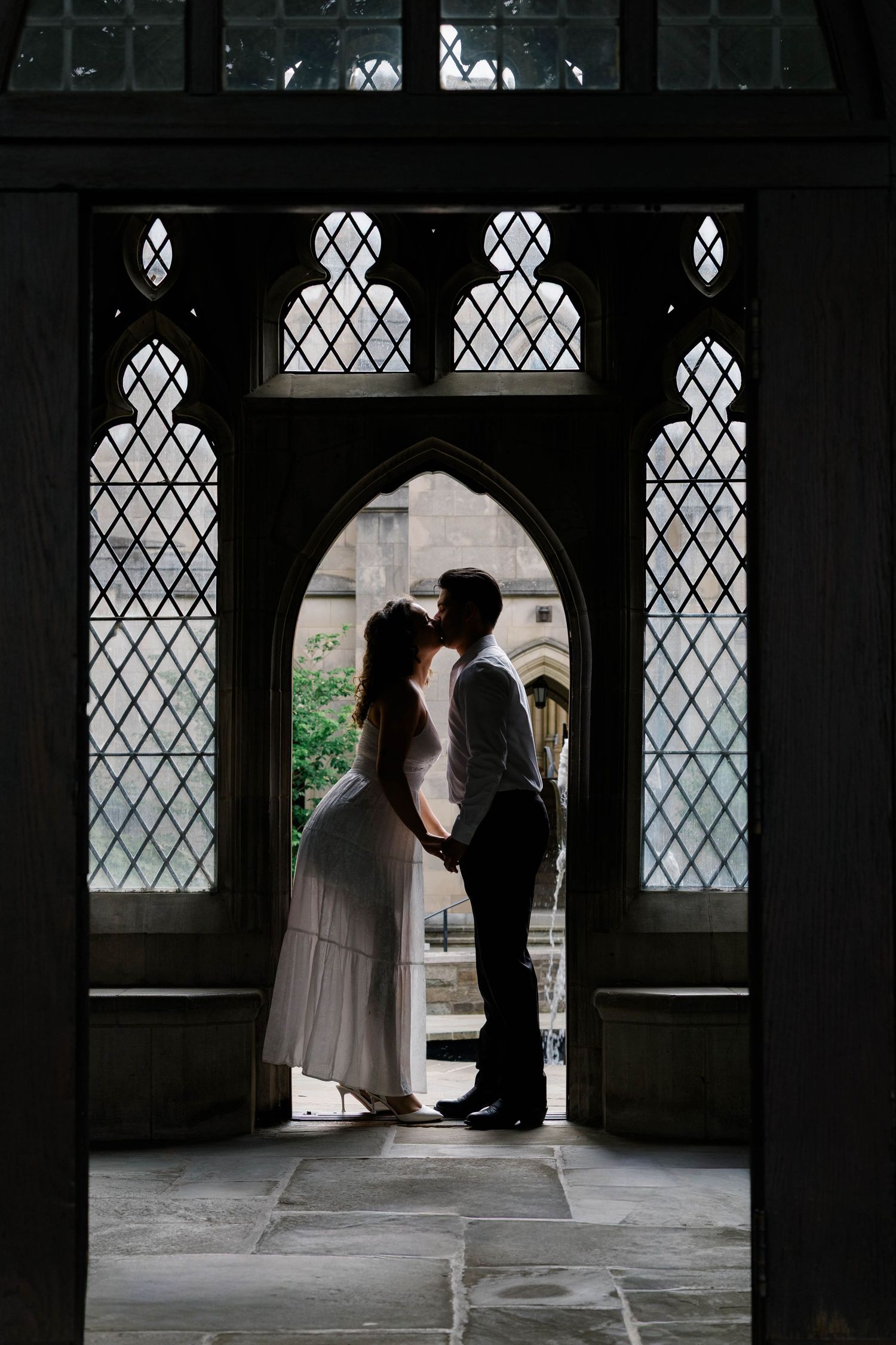 A portrait of a couple kissing at the National Cathedral in Washington, D.C.