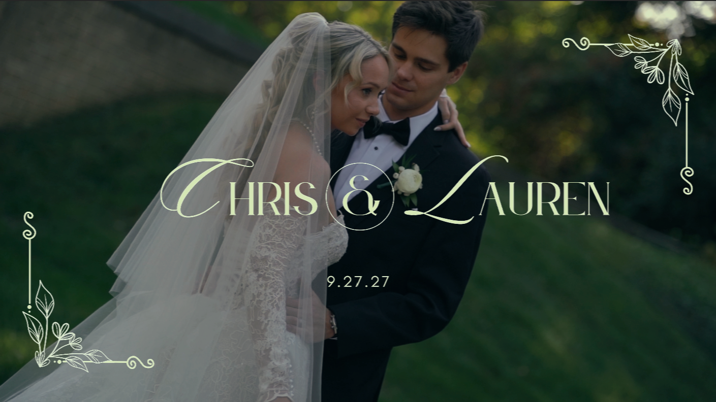Bride in a lace gown and long veil embraces groom in a black tuxedo in a wedding video title card for Chris and Lauren, dated 9.27.27.