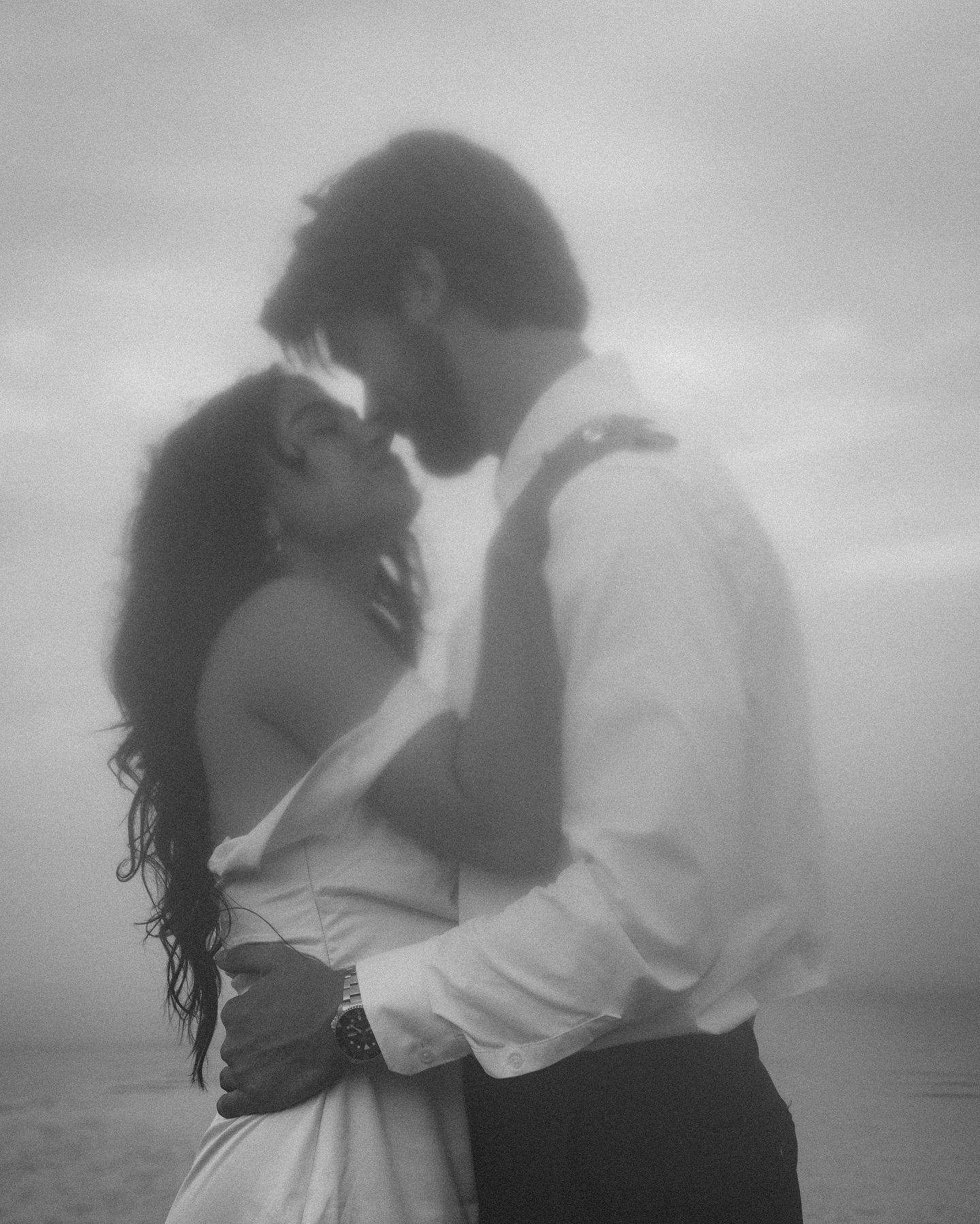 A romantic black and white photo series showing a couple embracing and dancing together in soft dreamy lighting.
