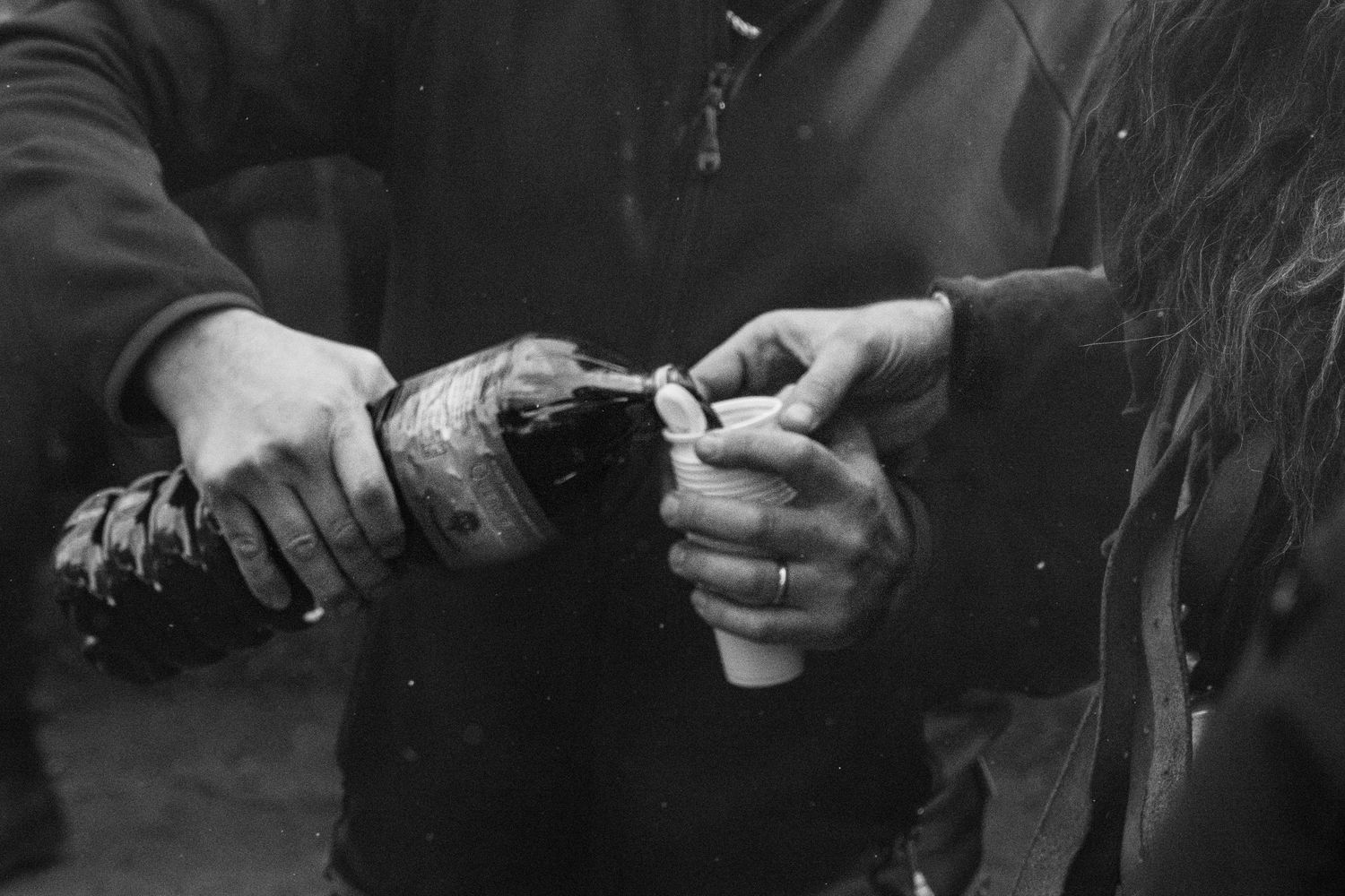 Traditional Mamuthones and Issohadores masks around the fire in Mamoiada, Sardinia - Black and white reportage by Marco Eretta