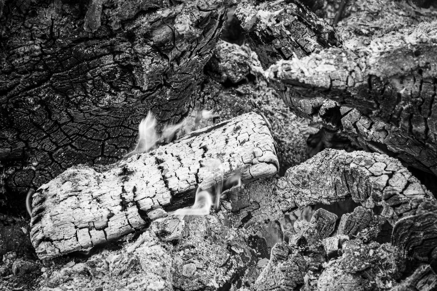 Traditional Mamuthones and Issohadores masks around the fire in Mamoiada, Sardinia - Black and white reportage by Marco Eretta