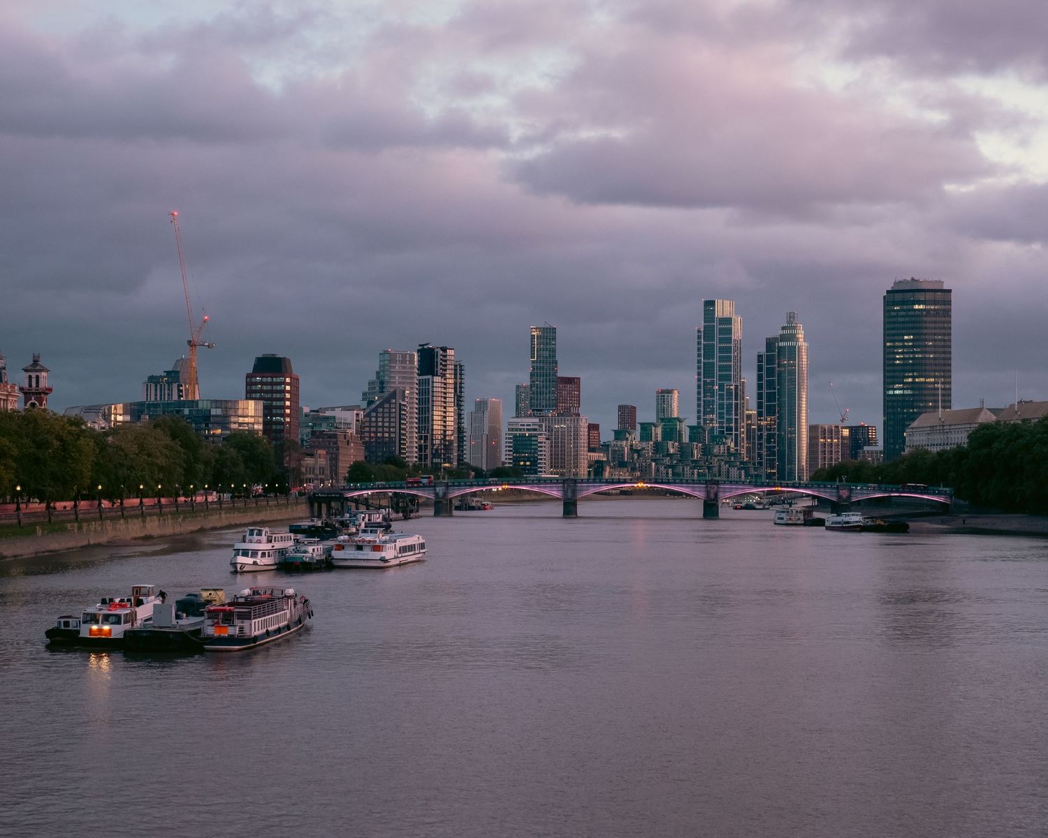 Skyline di Londra (City) al tramonto visto dal fiume con barche ormeggiate. London City skyline from the river, dusk. MEvisual Marco Eretta